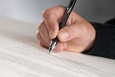 image of man signing contract